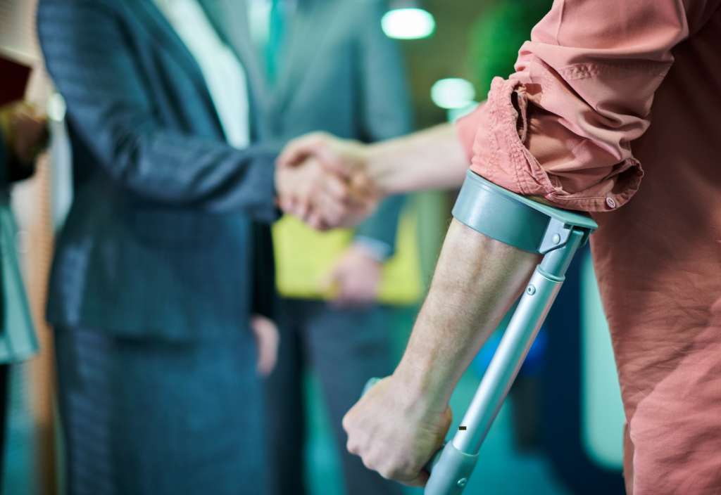 Image of an injured worker shaking hands with a colleague