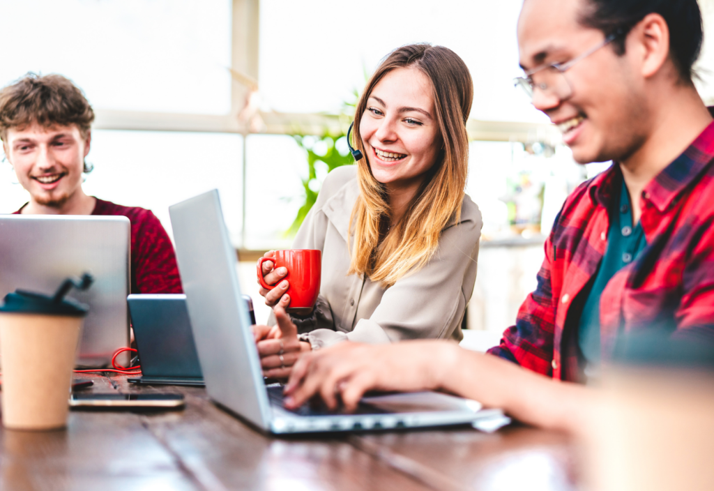 Image of a group of employees working at a desk together