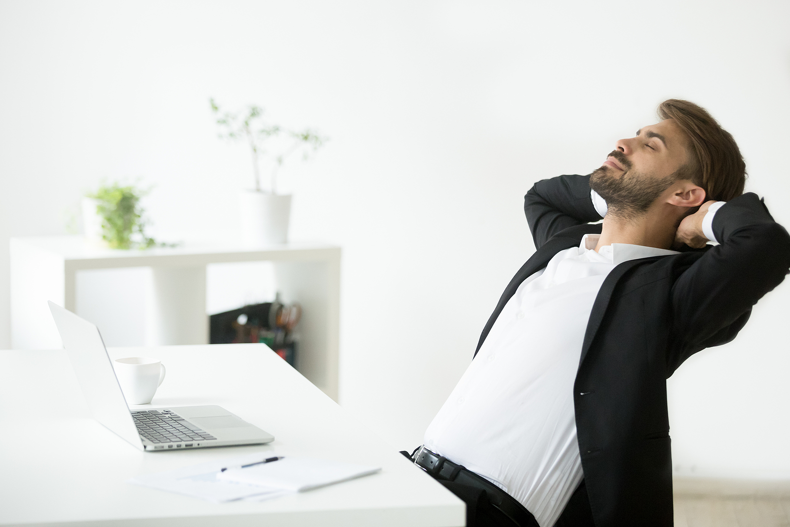 Image of a man relaxing at a desk