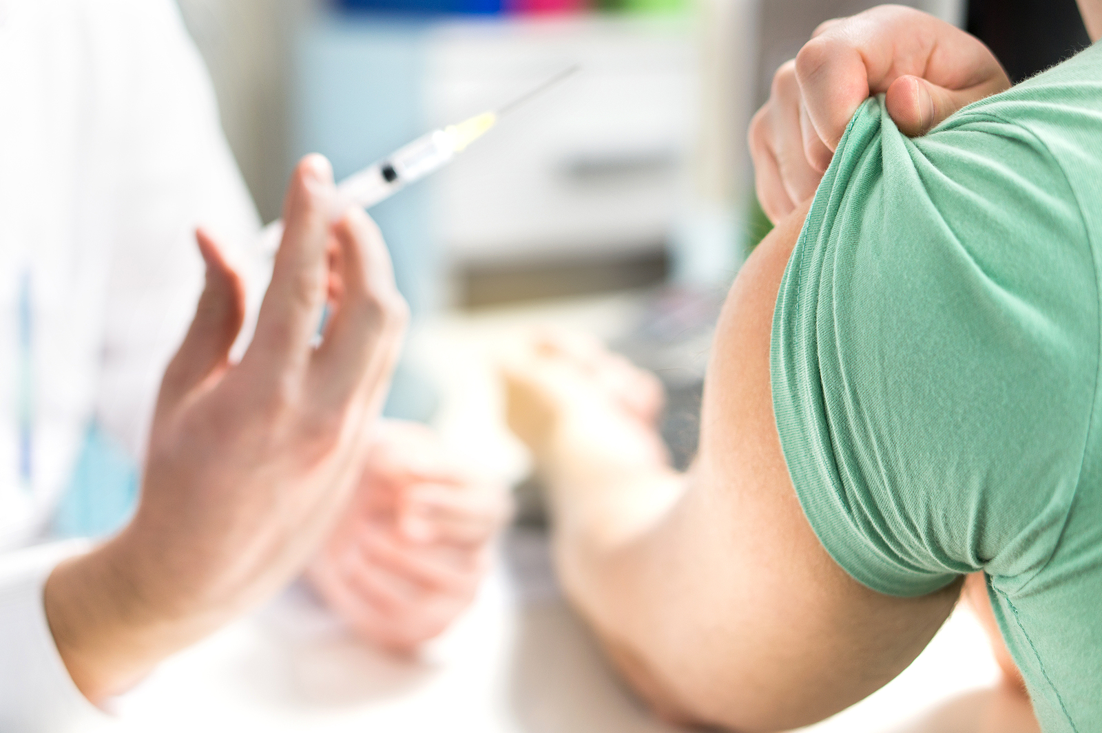 Image of a person giving another person a flu shot