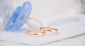 Image of wedding rings and a pacifier