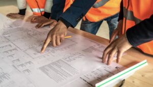 Image of construction workers consulting over a document